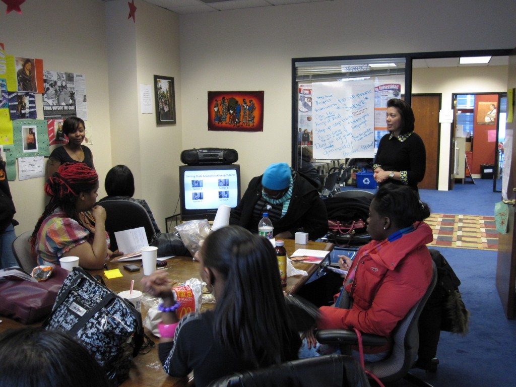 Michelle T. Sterling lends her time educating young women on the importance of make-up application.