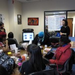 Michelle T. Sterling lends her time educating young women on the importance of make-up application.