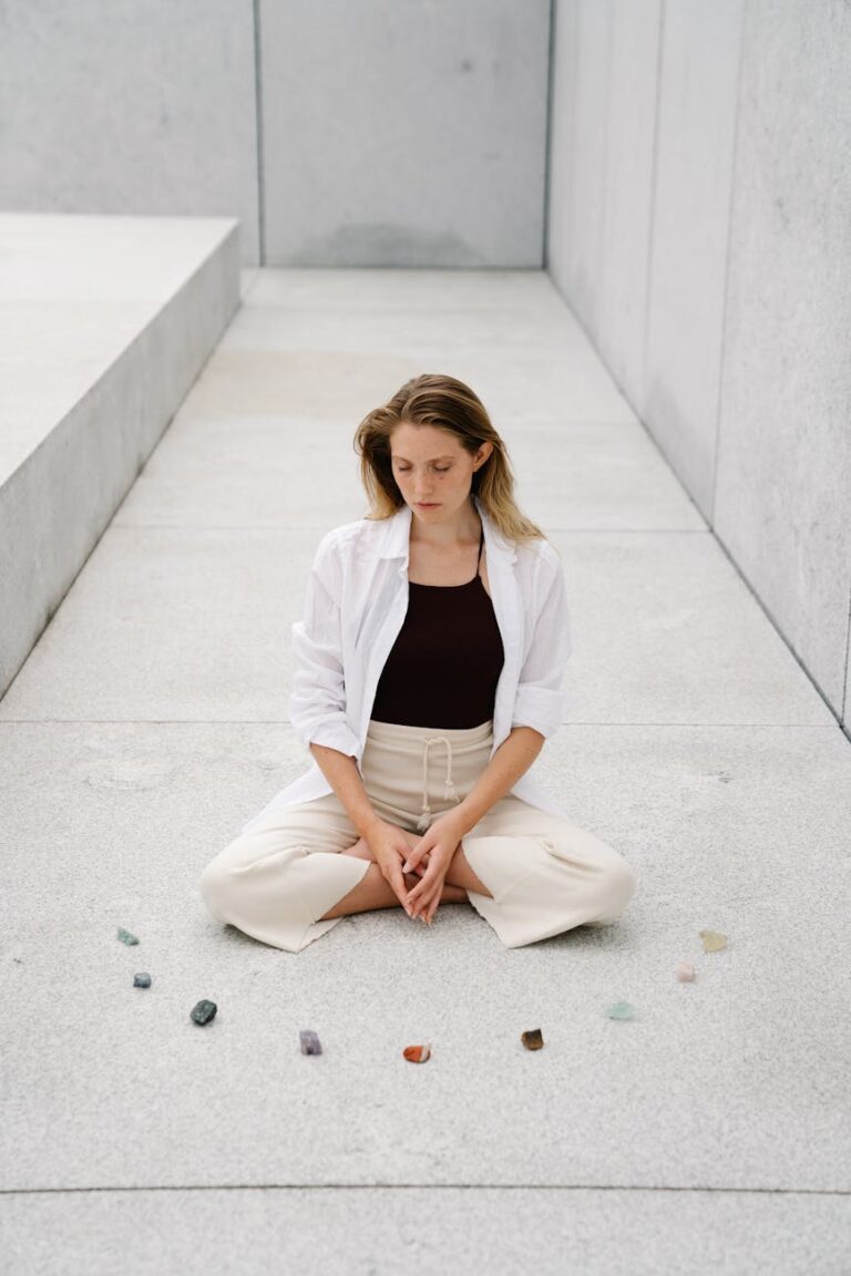 woman meditating next to mineral rocks