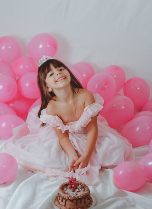 happy little adorable girl with tasty chocolate birthday cake