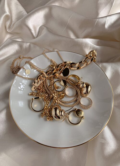 golden accessories on white saucer