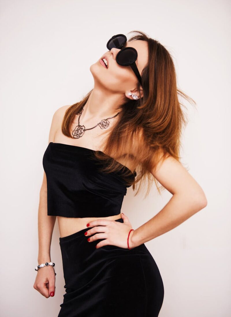 woman wearing black crop top standing under white background