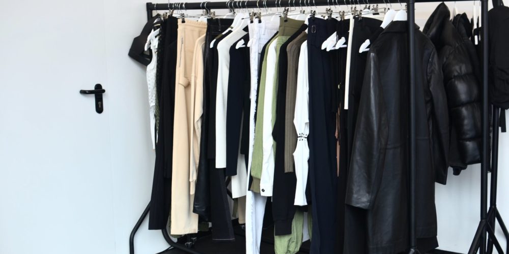 collection of garments hanging on rack