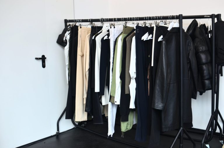 collection of garments hanging on rack