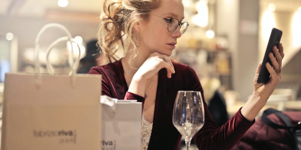 photo of woman holding her phone