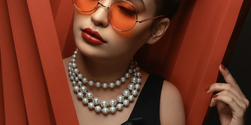 woman in sunglasses with beaded necklace