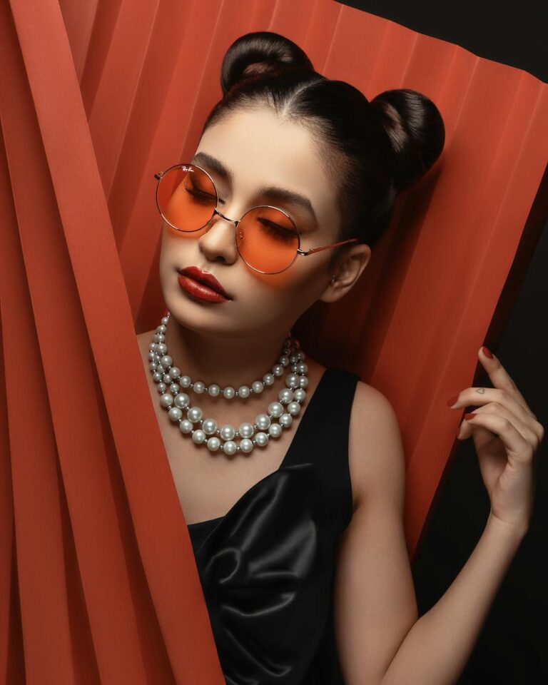 woman in sunglasses with beaded necklace