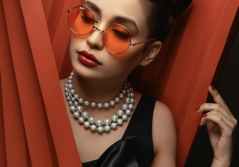 woman in sunglasses with beaded necklace